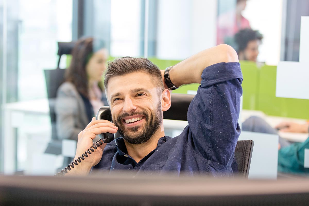 A man smiles on the phone as Smart Data Center's virtual server provides a secure cloud environment © Shutterstock, sirtravelalot